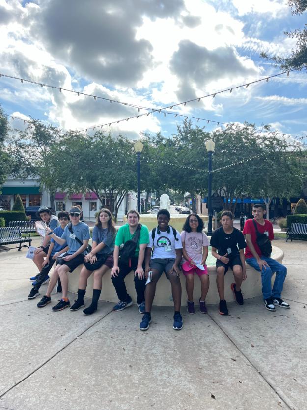 kids sitting on fountain